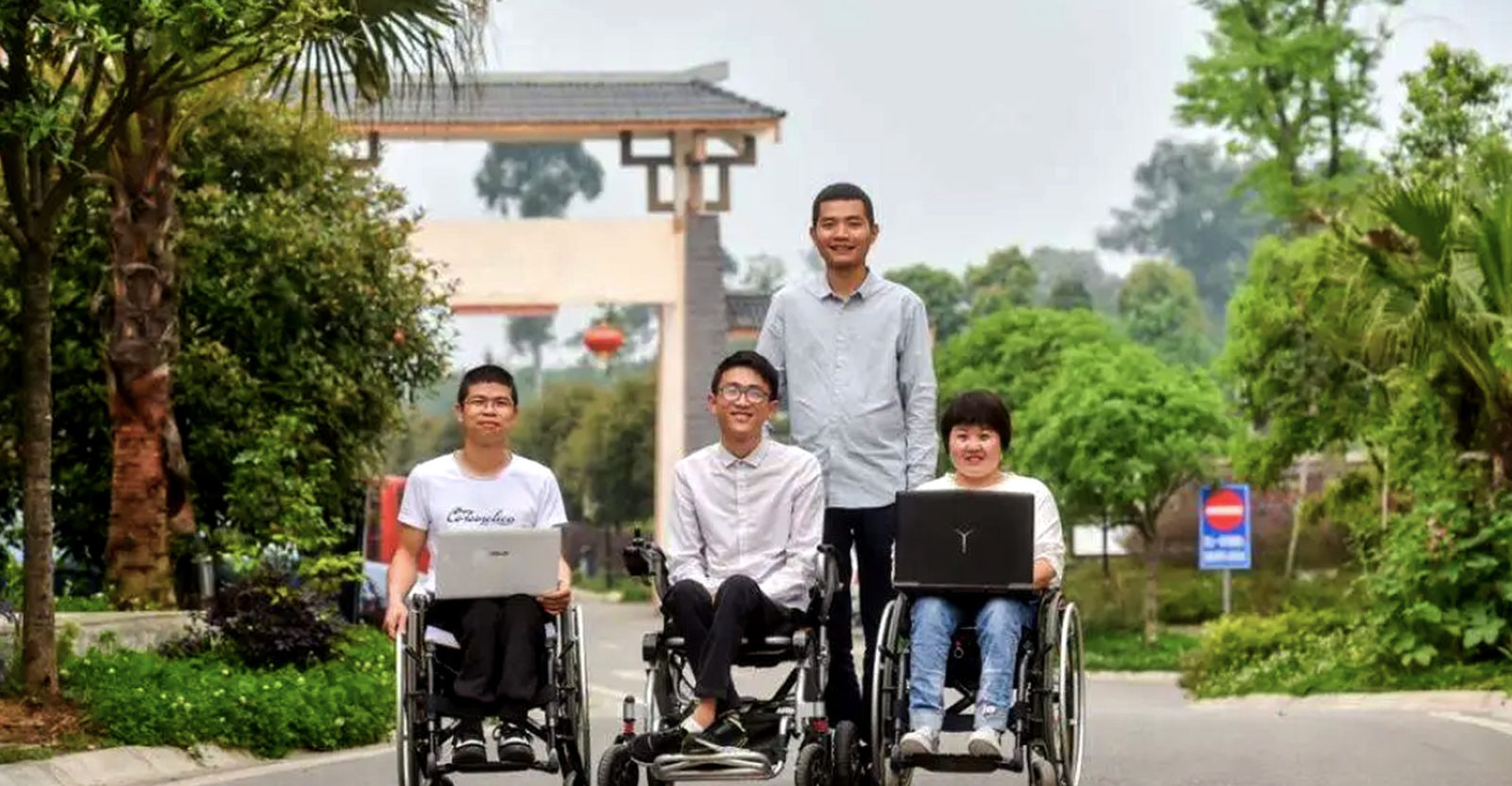 Yang, 2nd from left and Wu, standing, with the “Let’s Go Together” team.